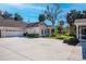 Charming one-story home with a well-maintained lawn, a spacious driveway, and an attached garage at 1407 Red Oak Ln, Port Charlotte, FL 33948