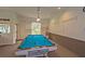 Bright community game room with a well-lit billiard table ready for a game at 1407 Red Oak Ln, Port Charlotte, FL 33948