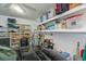 Spacious garage with ample storage shelving and space for parking, offering practical organization solutions at 1407 Red Oak Ln, Port Charlotte, FL 33948