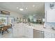 Bright, modern kitchen that looks into breakfast nook and comfortable living room at 1407 Red Oak Ln, Port Charlotte, FL 33948