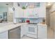 Bright kitchen featuring white cabinets and modern stainless steel appliances at 1407 Red Oak Ln, Port Charlotte, FL 33948