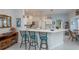 Kitchen island with seating and bright, neutral decor at 1407 Red Oak Ln, Port Charlotte, FL 33948
