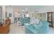 Open-concept living room with tile floors, comfortable seating, and a view into other rooms at 1407 Red Oak Ln, Port Charlotte, FL 33948