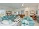 Bright living room with comfortable seating and a glimpse into the kitchen at 1407 Red Oak Ln, Port Charlotte, FL 33948
