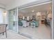 Open floor plan view from sunroom to living room, featuring bar top seating at 1407 Red Oak Ln, Port Charlotte, FL 33948