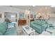 Bright living room with light blue sofas and a view into a sunroom at 1407 Red Oak Ln, Port Charlotte, FL 33948