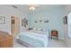 Serene main bedroom featuring calming blue walls and decorative wall art at 1407 Red Oak Ln, Port Charlotte, FL 33948