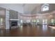 Spacious meeting room with a stone fireplace, high ceilings, and ample seating at 1407 Red Oak Ln, Port Charlotte, FL 33948