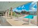 Relaxing pool area with comfortable lounge chairs and a covered patio for shade at 1407 Red Oak Ln, Port Charlotte, FL 33948