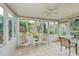 Bright sunroom with tile floors, many windows and an outdoor view at 1407 Red Oak Ln, Port Charlotte, FL 33948
