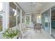 Sunroom with tile floor, large windows, and views of lush green trees at 1407 Red Oak Ln, Port Charlotte, FL 33948