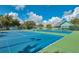 Community tennis courts, meticulously maintained and set against a backdrop of a clubhouse at 1407 Red Oak Ln, Port Charlotte, FL 33948
