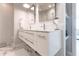 Modern bathroom with a double vanity, marble countertop, and floating shelves at 141 Tropicana Dr # 1111, Punta Gorda, FL 33950