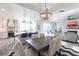 Open concept dining room with kitchen view and grey table at 141 Tropicana Dr # 1111, Punta Gorda, FL 33950