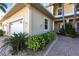 Well-maintained home exterior with a walkway, landscaping, and attached garage at 141 Tropicana Dr # 1111, Punta Gorda, FL 33950
