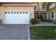 White garage door with decorative windows and brick paver driveway at 141 Tropicana Dr # 1111, Punta Gorda, FL 33950