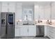 White kitchen with stainless steel appliances and a farmhouse sink at 141 Tropicana Dr # 1111, Punta Gorda, FL 33950