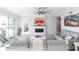 Spacious living room with gray sofas, a fireplace, and access to a patio at 141 Tropicana Dr # 1111, Punta Gorda, FL 33950