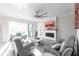 Light and airy living room featuring a fireplace, comfortable seating, and an open floor plan at 141 Tropicana Dr # 1111, Punta Gorda, FL 33950