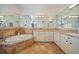 Spa-like bathroom with a large soaking tub and double vanity at 1412 Sea Fan Dr, Punta Gorda, FL 33950