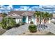 Attractive home with a teal door, paver driveway, and lush landscaping at 1412 Sea Fan Dr, Punta Gorda, FL 33950