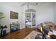 Bright home office with hardwood floors, view of living area, and fitness equipment at 1412 Sea Fan Dr, Punta Gorda, FL 33950