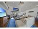 Open living space with hardwood floors, sectional sofa, and water views at 1412 Sea Fan Dr, Punta Gorda, FL 33950