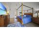 Main bedroom with king-size bed, wood floors, and access to the pool at 1412 Sea Fan Dr, Punta Gorda, FL 33950