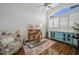 Home office with hardwood floors, wooden desk, and teal cabinet at 1412 Sea Fan Dr, Punta Gorda, FL 33950