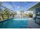 Inviting screened pool with canal views and a grill at 1412 Sea Fan Dr, Punta Gorda, FL 33950