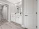 Modern bathroom featuring a double sink vanity, a large mirror, and bright white cabinets at 16031 Hesta Misty Ct, Punta Gorda, FL 33955