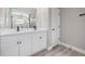 Modern bathroom features a double sink vanity, a large mirror, and white cabinets at 16031 Hesta Misty Ct, Punta Gorda, FL 33955