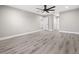 Open bedroom space with hard flooring, a ceiling fan, and access to the rest of the house at 16031 Hesta Misty Ct, Punta Gorda, FL 33955