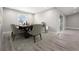 Neutral dining room with wood flooring, a modern table set, and a sliding glass door at 16031 Hesta Misty Ct, Punta Gorda, FL 33955