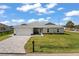 Charming single-story home features a neatly paved driveway, a lush green lawn, and tasteful landscaping at 16031 Hesta Misty Ct, Punta Gorda, FL 33955