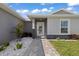 Inviting front entrance with a stone-paved walkway, a stylish glass door, and decorative rock accents at 16031 Hesta Misty Ct, Punta Gorda, FL 33955