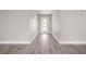 Hallway with elegant gray vinyl flooring and a door letting in ample natural light at 16031 Hesta Misty Ct, Punta Gorda, FL 33955