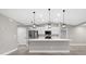 Bright kitchen features stainless steel appliances, modern lighting, and a large center island at 16031 Hesta Misty Ct, Punta Gorda, FL 33955