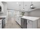Open kitchen with stainless steel appliances, a white countertop, and views to an adjacent living space at 16031 Hesta Misty Ct, Punta Gorda, FL 33955