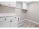 Well-organized laundry room features ample cabinet space and quartz countertops at 16031 Hesta Misty Ct, Punta Gorda, FL 33955