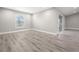 Spacious living room with natural light, wood flooring, and neutral paint at 16031 Hesta Misty Ct, Punta Gorda, FL 33955
