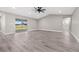 Expansive living room features vinyl plank flooring, a ceiling fan, and sliding doors to the lanai at 16031 Hesta Misty Ct, Punta Gorda, FL 33955