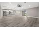 Modern living room features an open floor plan connecting the kitchen and dining area at 16031 Hesta Misty Ct, Punta Gorda, FL 33955