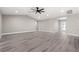 Spacious living room with gray vinyl plank flooring and a ceiling fan at 16031 Hesta Misty Ct, Punta Gorda, FL 33955