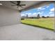 Covered patio overlooking a green lawn and neighborhood with a ceiling fan and screened-in walls at 16031 Hesta Misty Ct, Punta Gorda, FL 33955