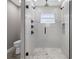Sleek glass shower featuring multi-fixture shower system, decorative shower tile, and a built-in niche at 16031 Hesta Misty Ct, Punta Gorda, FL 33955