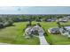 Aerial view of single-Gathering home with large backyard and surrounding landscape at 1617 Blue Lake Cir, Punta Gorda, FL 33983