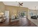 Bright living room with hardwood floors, comfy seating, and access to a screened lanai at 1617 Blue Lake Cir, Punta Gorda, FL 33983