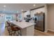 Modern kitchen with white cabinets, stainless steel appliances and breakfast bar at 16255 Lady Palm Dr, Port Charlotte, FL 33953