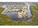 Aerial view showcasing a waterfront property in a residential area at 16920 Ohara Dr, Port Charlotte, FL 33948